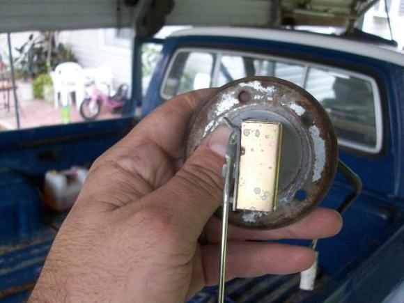tab was bent at  a 90 degree angle now its bent far enough back to let he gauge drop to E. Float does not hit bottom of tank. I tried to bend the rod but it did not make a differnce