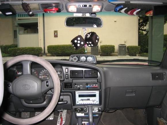 better view of the OEM altimeter/tilt gauge.   Also you can see the aftermarket pedals (Wal-Mart, $25) ProLock anti-theft (with the red lanyard attached) and 12V Cellphone charger/GPS adapter.  There's a compass behind the rear-view mirror ($3 Wal-Mart) and FastTrak, the Bay-Area automatic bridge toll radio thing.  Also note the MP3 player mounted in the ashtray.

Also, I slipped a small flat-blade eyeglass screwdriver on the sides of the plastic air vents to remove them, put them in the dishwasher (yeah i know but it was quick and effective) to clean them out.