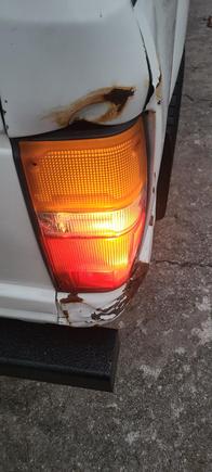 Passenger side with tail light bleeding through into white reverse reflector