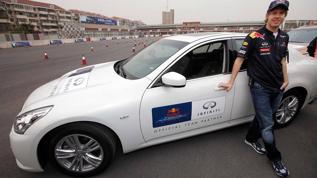 Sebastian Vettel at a track with the Infiniti G37 and FX50 