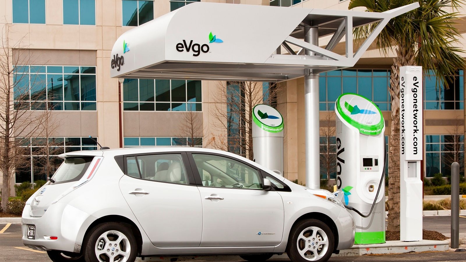 Nissan Leaf electric car with eVgo quick charging station. [courtesy eVgo]