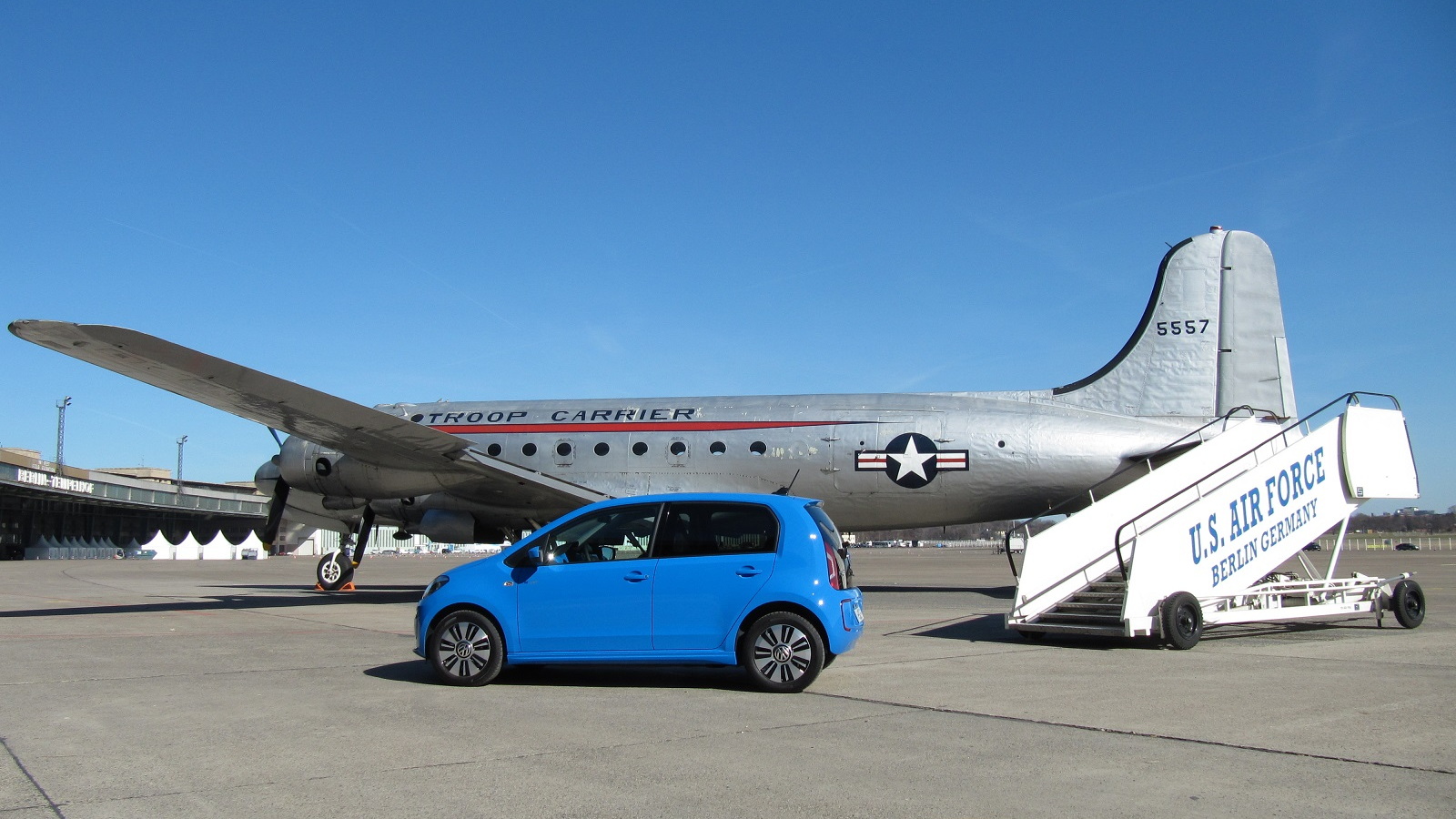 Volkswagen e-Up electric car with Douglas C54 transport plane at Berlin's Tempelhof Airport