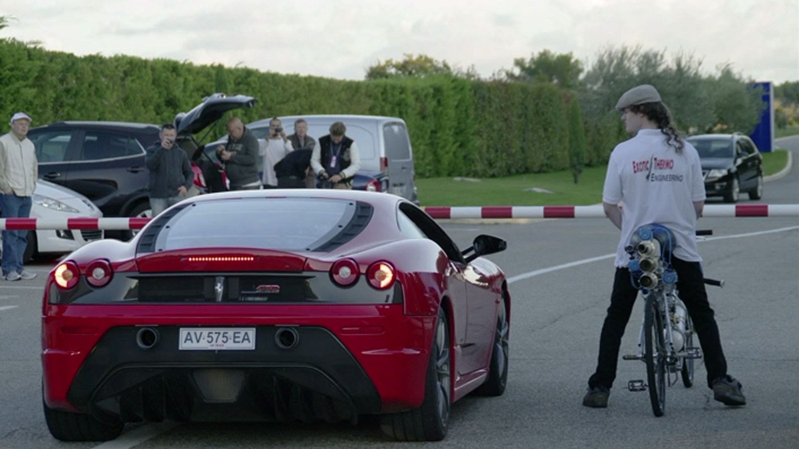 Ferrari F430 Scuderia drag races a rocket-powered bicycle