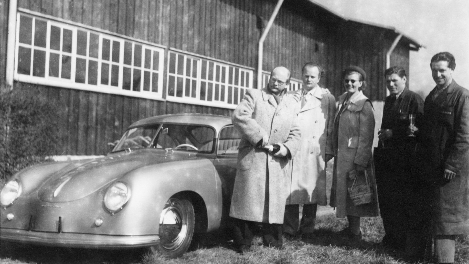 Ottomar Domnick (first from left) takes delivery of the first customer Porsche on May 26, 1950
