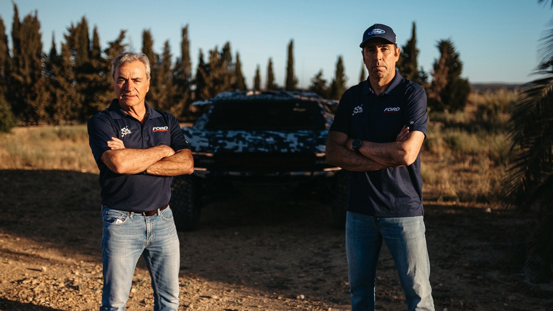 Carlos Sainz Sr. (left) and Nani Roma (right) with 2025 Dakar Rally Ford Raptor